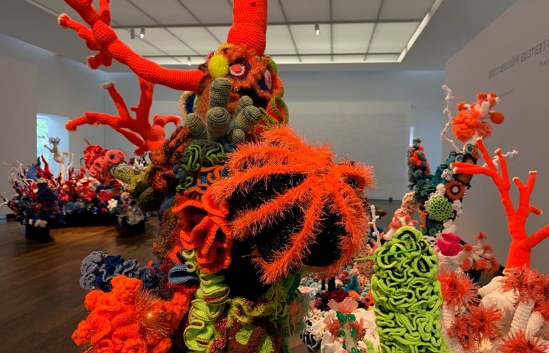 A colorful coral reef made out of wool to raise awareness about climate change, at a museum in Baden-Baden, Germany, in January 2022 | REUTERS