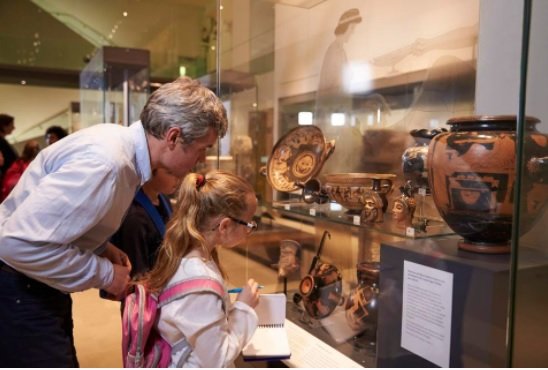 Teacher And Pupils Looking At Artifacts On Display In Museum GETTY.jpg